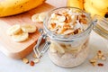 Overnight oats with bananas and nuts on white marble Royalty Free Stock Photo