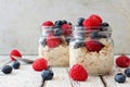 Overnight oats with blueberries and raspberries on a white wood background Royalty Free Stock Photo