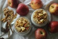 Overnight oats with apple and almonds. Made by soaking rolled oats and chia seeds in milk served with chopped apples, cinnamon,