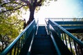 Overpass steel stairs on background , walkway up on blue white sky and green tree background Royalty Free Stock Photo