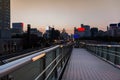 Overpass walkway with city blurred background.