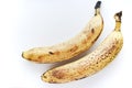 Overripe bananas on a white background. Ripe yellow fruit