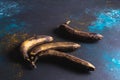Overripe yellow-black bananas on dark blue background. Minimalist