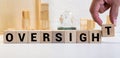 Oversight concept, word Oversight on wooden block Royalty Free Stock Photo