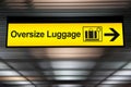 Oversize luggage yellow sign with arrow direction Royalty Free Stock Photo