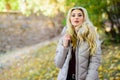 Oversized jacket trend. How to rock puffer jacket like star. Girl fashionable blonde walk in autumn park. Woman wear