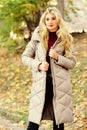 Oversized jacket trend. How to rock puffer jacket like star. Puffer fashion trend concept. Girl fashionable blonde walk