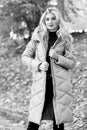 Oversized jacket trend. How to rock puffer jacket like star. Puffer fashion trend concept. Girl fashionable blonde walk