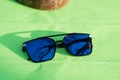Oversized sunglasses model with big blue lenses shoot outside in a summer day closeup . Selective focus