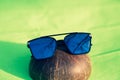 Oversized sunglasses model with big blue lenses shoot outside in a sunny day closeup . Selective focus