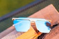 Oversized sunglasses model with blue lenses closeup . Selective focus