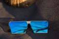 Oversized sunglasses model with blue lenses shoot outside in a sunny day closeup . Selective focus