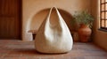 Oversized woven tote bag in a rustic interior setting showcasing natural textures and earthy tones Royalty Free Stock Photo