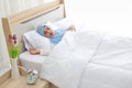 Oversleeping asian muslim woman wearing white sleepwear lying on bed with happiness.Top view portrait young cute girl sleeping