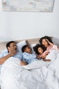 overslept and shocked african american couple