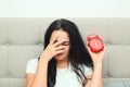 Overslept woman with alarm clock in bed. Early morning awaking Royalty Free Stock Photo