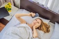 Overslept woman with surprised expression while looking at phone after missed the alarm and woke up late Royalty Free Stock Photo