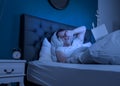 An overtired man works at night on his laptop Royalty Free Stock Photo