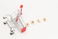 Overturn toys shopping basket and word SALE made from wooden blocks