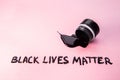Overturned can of black paint, paint spilled from the can with note. Black Lives Matter. Equal Symbol. No racism concept
