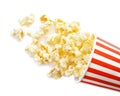 Overturned cup with delicious fresh popcorn on white background Royalty Free Stock Photo