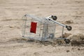 Overturned Empty Supermarket Shopping Cart