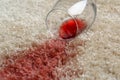 Overturned glass and spilled red wine on soft carpet, closeup Royalty Free Stock Photo