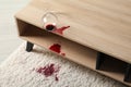 Overturned glass and spilled red wine on white carpet indoors Royalty Free Stock Photo