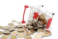 Overturned red miniature shopping cart filled with new 10 Thai Baht coins. Royalty Free Stock Photo