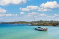 Overturned shipwrecked sunken sail boat yacht with seaweed growing on it in a sea bay. Vacation gone wrong. Greece