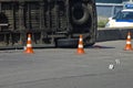 Overturned transport on accident site with traffic cones