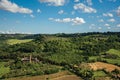 Overview of green hills, vineyards, forests and towered stronghold in a sunny day. In front of the Orvieto town.