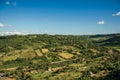 Overview of green hills, vineyards, forests and villas in a sunny day. In front of Orvieto.