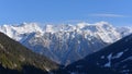 Overview of a large chain of snow-capped mountains