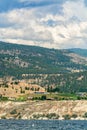 Overview of Okanagan lake with mountains and clouds background.