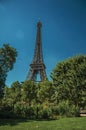 Overview of stunning Eiffel Tower and greenery under sunny blue sky in Paris. Royalty Free Stock Photo