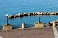 Overview of the Taranto seafront. Mar Grande with lampposts and rocks. Puglia, Italy