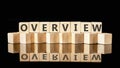 OVERVIEW text assembled from wooden cubes on a black background