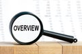 OVERVIEW text on the magnifiyng. Magnifying glass on the background of columns of numbers Royalty Free Stock Photo