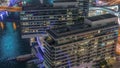 Overview to JBR and Dubai Marina skyline with modern high rise skyscrapers waterfront living apartments aerial night