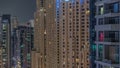 Overview to JBR and Dubai Marina skyline with modern high rise skyscrapers waterfront living apartments aerial night