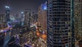 Overview to JBR and Dubai Marina skyline with modern high rise skyscrapers waterfront living apartments aerial night Royalty Free Stock Photo