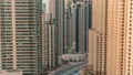 Overview to JBR and Dubai Marina skyline with modern high rise skyscrapers waterfront living apartments aerial timelapse