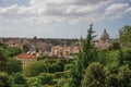 Overview of trees, cathedrals domes, monuments and roofs on a cloudy day at Rome. Royalty Free Stock Photo