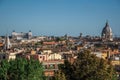 Overview of trees, cathedrals domes and roofs of buildings in the sunset of Rome. Royalty Free Stock Photo