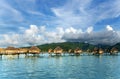 Overwater bungalows stretching and a wooden bridge out across the lagoon in Bora Bora island