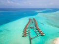 Overwater villas and white sand beach on tropical island for holidays vacation travel and honeymoon. Luxury resort hotel in Royalty Free Stock Photo