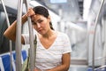 Overweary woman waiting for her stop in metropolitan train Royalty Free Stock Photo