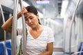 Overweary woman waiting for her stop in metropolitan train Royalty Free Stock Photo