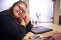 Chubby teacher sitting in a bright coffee shop